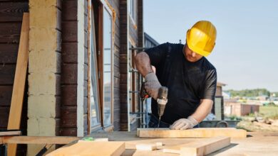 A carpenter drilling a wood.