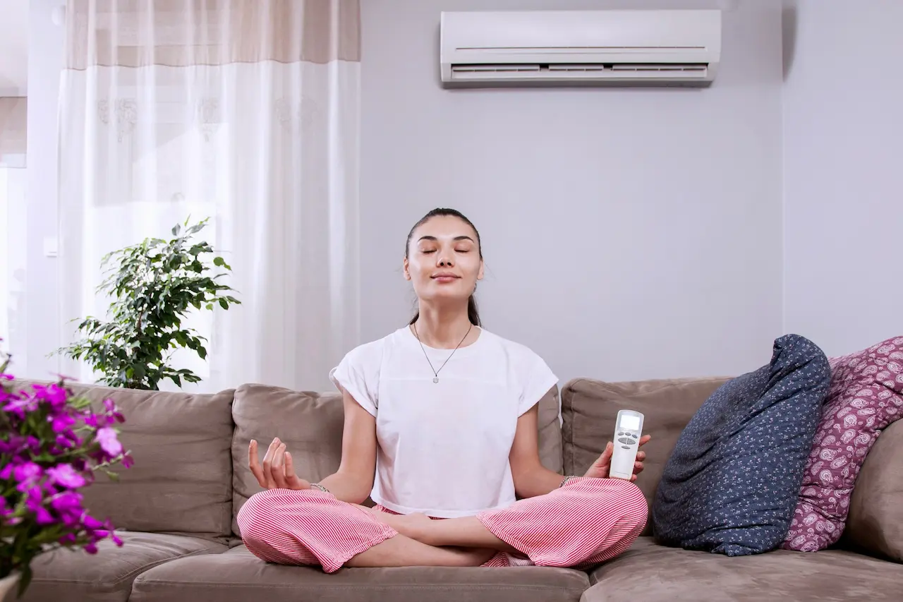 Lady Meditating In Front Of Air Conditioner