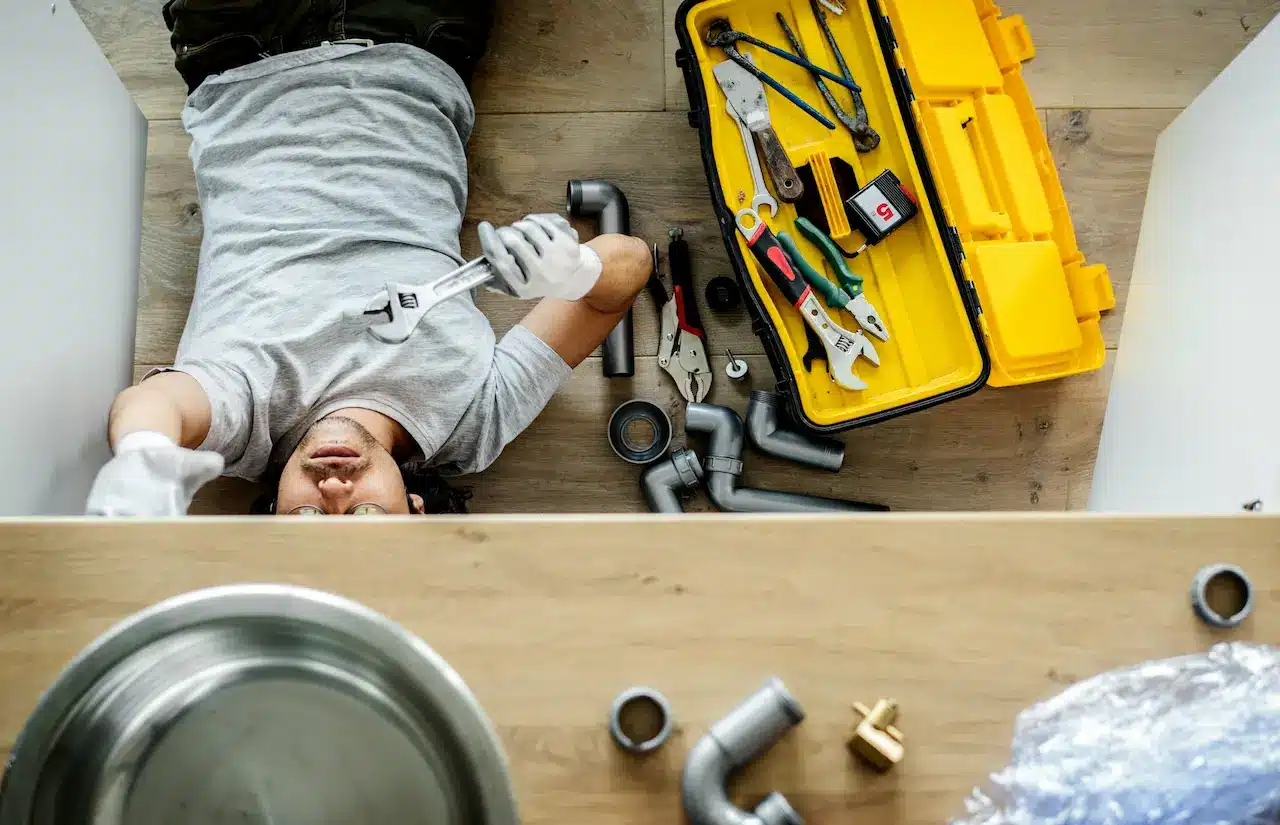 Plumber Under A Sink